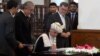 Afghan President Ashraf Ghani (C) signs a peace deal with Afghan warlord Gulbuddin Hekmatyar at the Presidential Palace in Kabul on September 29.