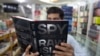 A customer in an Islamabad bookstore looks at Spy Chronicles, a new tell-all tome by former Indian and Pakistani intelligence chiefs that has caused a storm in both countries.