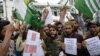 Protesters shout slogans at a rally against the Indian government's move to strip Jammu and Kashmir of its autonomy and impose a communications blackout, in Srinagar on August 16.