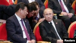 Russian President Vladimir Putin (right) and his Chinese counterpart Xi Jinping attend a gala concert in Shanghai on May 20. 