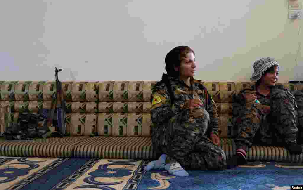 Syria -- Female Kurdish fighters from the People's Protection Units (YPG) sit in a house in Raqqa, June 15, 2017