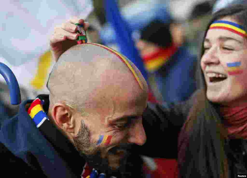 A Moldovan student gets facepaint applied before attending a rally calling for the reunification of Moldova and Romania as well as to commemorate Romania's National Day in Chisinau. (Reuters/Gleb Garanich)