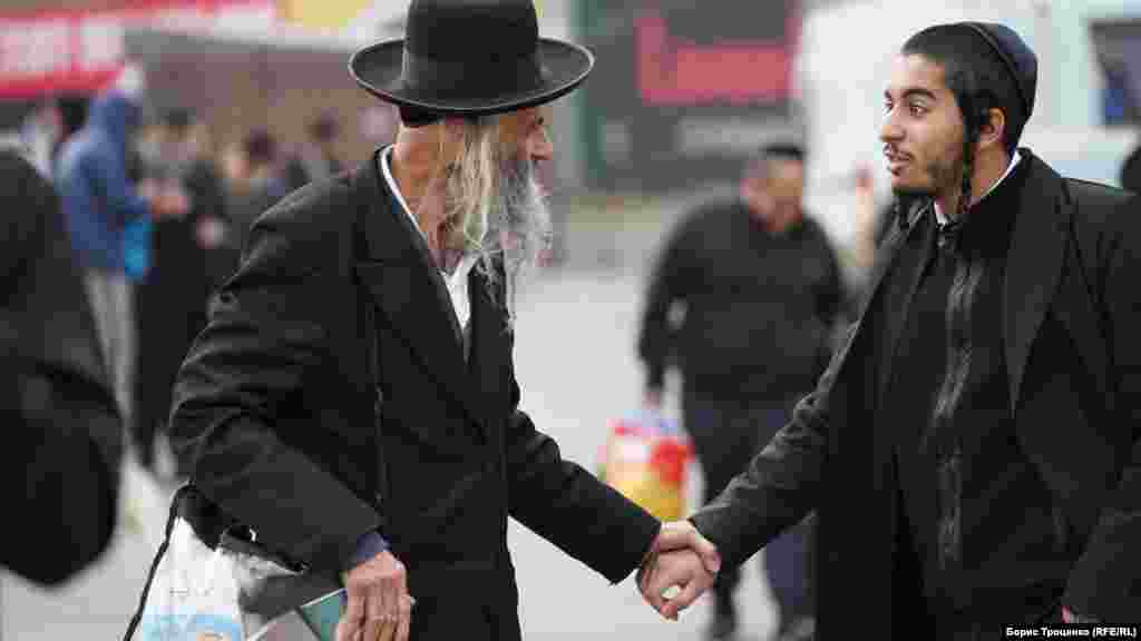 Older and younger pilgrims meet for talks in the streets