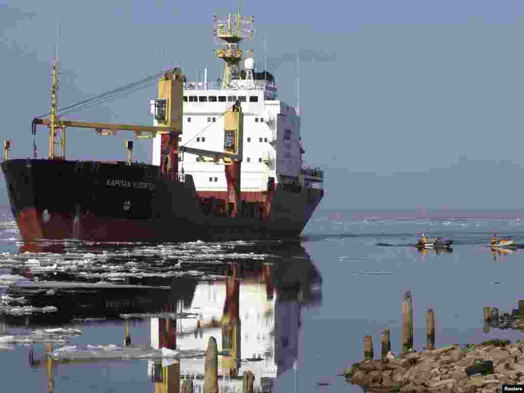 Activists of the environmental group Greenpeace approach the Russian cargo vessel Kapitan Kuroptev, which is carrying tons of toxic and radioactive waste, to try to prevent it from entering the port of St. Petersburg. Photo by Alexander Demianchuk for Reuters