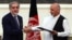 Afghan presidential candidates Abdullah Abdullah (left) and Ashraf Ghani shake hands after signing a power-sharing agreement at the Presidential Palace in Kabul on September 21.