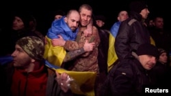 Ukrainian POWs react after a prisoner swap at an unknown location in Ukraine earlier this year. 