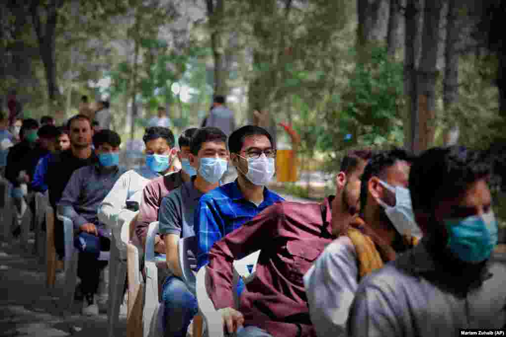 Afghan students wait to receive a dose of a COVID-19 vaccine at Kabul University on July 29.&nbsp;