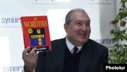 Armenia - Presidential candidate Armen Sarkissian holds a copy of a once popular video game during a visit to the Yerevan headquarters of Synopsis Armenia company, 14 February 2018.