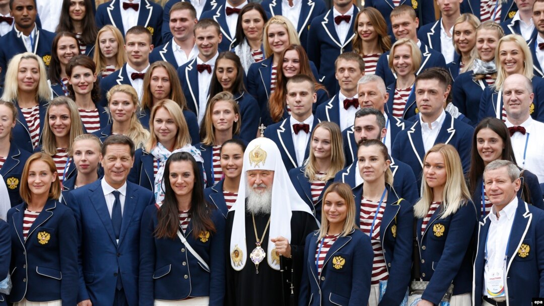 Russian Olympic team members pose for a family photo with Patriarch Kirill (center) at Uspensky Cathedral in Moscow on July 27.