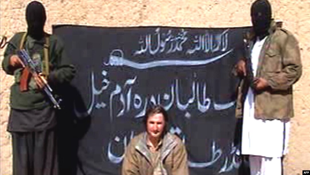 Armed Taliban militants guarding kidnapped Polish engineer Piotr Stanczak prior to executing him.