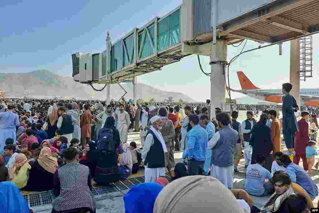 People crowded on to the airport tarmac.