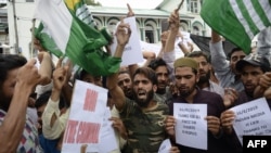 Protesters shout slogans at a rally against the Indian government's move to strip Jammu and Kashmir of its autonomy and impose a communications blackout, in Srinagar on August 16.