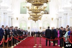 In this pool photograph distributed by Russian state agency Sputnik, guests arrive to Russia's president-elect Vladimir Putin inauguration ceremony at the Kremlin in Moscow on May 7, 2024.
