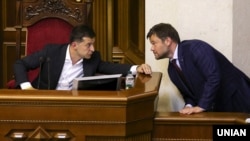 Ukrainian President Vladimir Zelenskiy (left) has parted ways with Andriy Bohdan (right), who many said was evidence of an oligarch's influence over him.