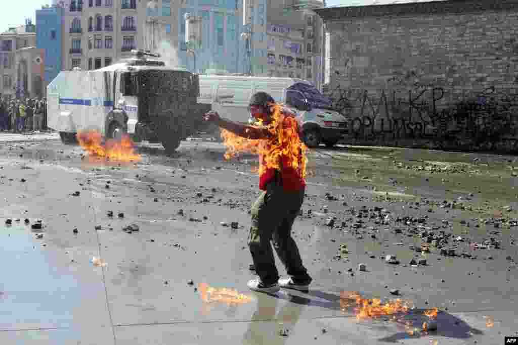 A demonstrator's clothes are set on fire during clashes with riot police on Istanbul's Taksim Square. (AFP/Oren Ziv)
