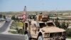 A U.S. soldier sits on an armored vehicle on a road leading to the tense front line with Turkish-backed fighters, in Manbij, April 4, 2018. File photo