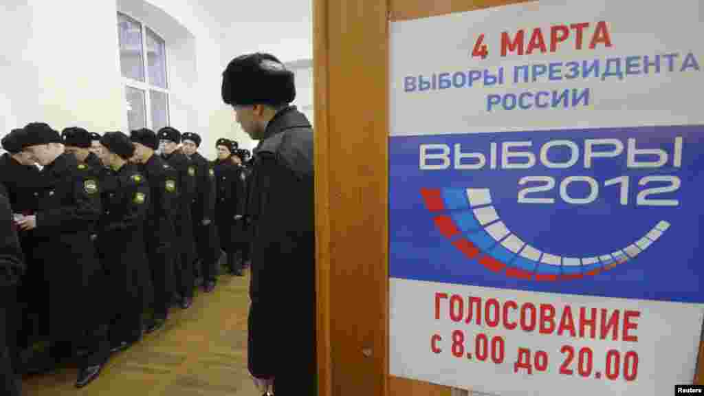 Sailors queue to vote at a polling station in the far eastern city of Vladivostok.