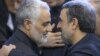 Commander of Quds force, Qassem Soleimani (left) shakes hands with President, Mahmoud Ahmadinejad, in the funeral of his mother, 2013.