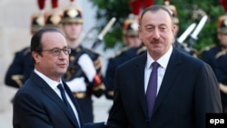 France -- French president Francois Hollande (L) greets president of Azerbaijan, Ilham Aliyev (R) as he arrives for a meeting at the Elysee Palace in Paris, October 27, 2014.