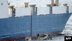 A U.S. Navy photo shows Somali pirates in small boats hijacking the ship.