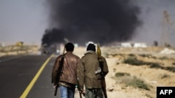 Smoke billows from the fighting today in Sidra, some 10 kilometers west of Ras Lanouf.