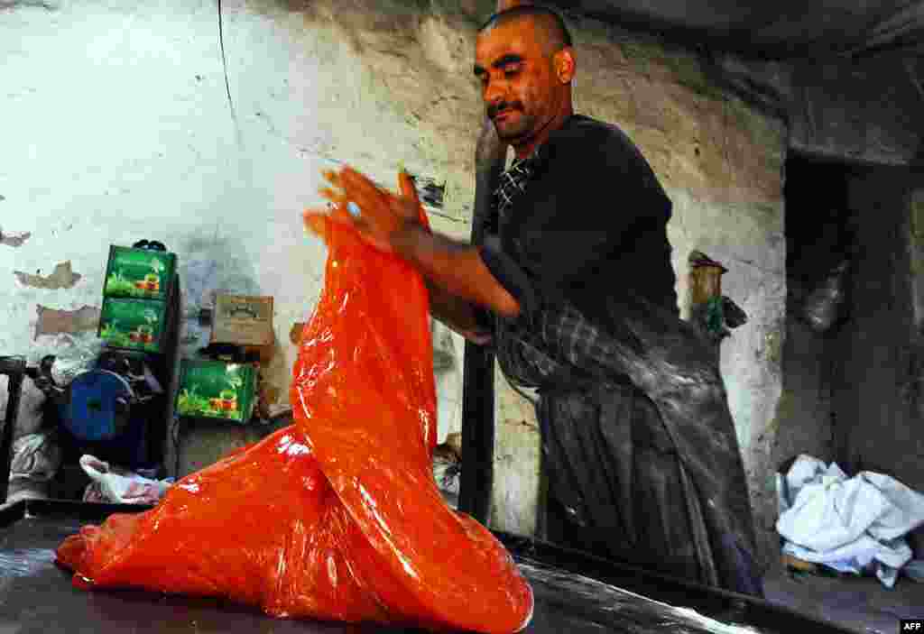 An Afghan confectioner works at a traditional sweets factory in Herat. (AFP/Aref Karimi)