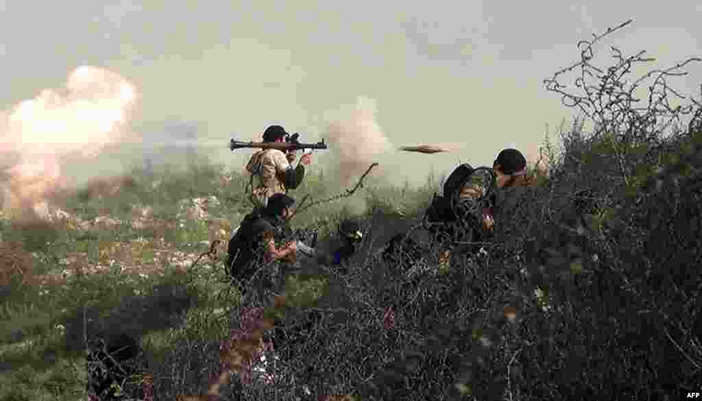 A video grab shows a Syrian opposition fighter firing a rocket-propelled grenade during clashes with regime forces over the strategic area of Khanasser. (AFP/Salah Al-Ashkar)