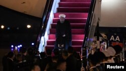 Iranian President Hassan Rouhani walks to his car after walking out from the airplane upon his arrival at Qingdao Liuting International Airport, Shandong province, China, June 8, 2018. Wang Zhao/Pool via REUTERS