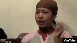 Асем Кенжебаева, жительница города Жанаозен, дочь погибшего Базарбая Кенжебаева. Фотоскриншот с видеосюжета телеканала "К-плюс". 