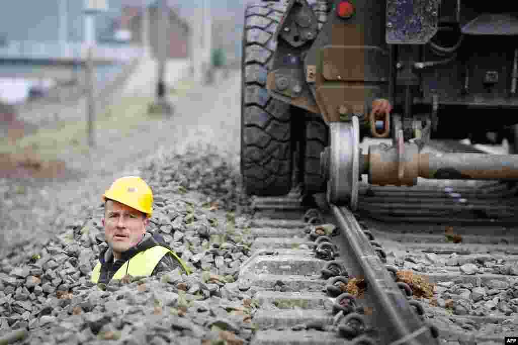 A Belgian engineer works on train tracks in Profondeville. The modernization of the line will enable the system to automatically stop a train that neglects a red light or exceeds the maximum speed limit. (AFP/Belga/Bruno Fahy)