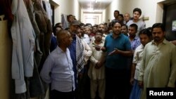 Foreign workers gather to speak to journalists at the Qadisiya labor camp in Saudi Arabia. (file photo) 