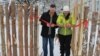 Former regional lawmaker Arkady Vasilyev and union leader Ulyana Mikhailova ceremonially open a fence at a Pskov school that is meant to protect students from a terrorist attack. 