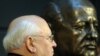 Mikhail Gorbachev stands next to a bust of himself after unveiling it in Berlin in November 2009.