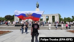 Российский прокремлевский байкер из клуба "Ночные волки" с российским флагом у советского мемориала в Берлине в 2018 году