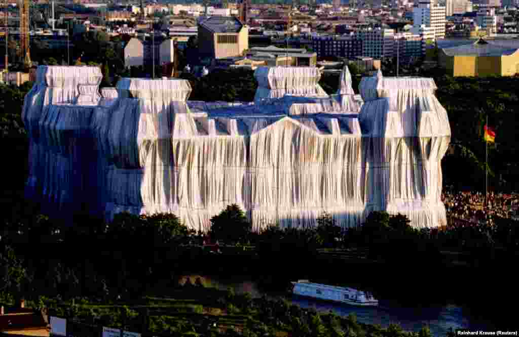 Sunset illuminates the German Reichstag, wrapped by Christo with silver polypropylene fabric. Christo said none of his projects was allowed to exist for more than two weeks. &quot;If you don&rsquo;t see it, you don&rsquo;t see it,&quot; he told The Guardian.&nbsp;