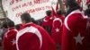 France -- People wearing the Turkish flag take part in a rally next to the French National Assembly in Paris, 22Dec2011