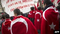 France -- People wearing the Turkish flag take part in a rally next to the French National Assembly in Paris, 22Dec2011