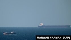 An oil tanker cruises towards the Strait of Hormuz off the shores of Khasab in Oman on January 15, 2012 Iran threatened to close the Strait of Hormuz in the Gulf if extra sanctions bite, cutting off the transport of 20 percent of the world's oil as United