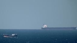 An oil tanker cruises towards the Strait of Hormuz off the shores of Khasab in Oman on January 15, 2012 Iran threatened to close the Strait of Hormuz in the Gulf if extra sanctions bite, cutting off the transport of 20 percent of the world's oil as United