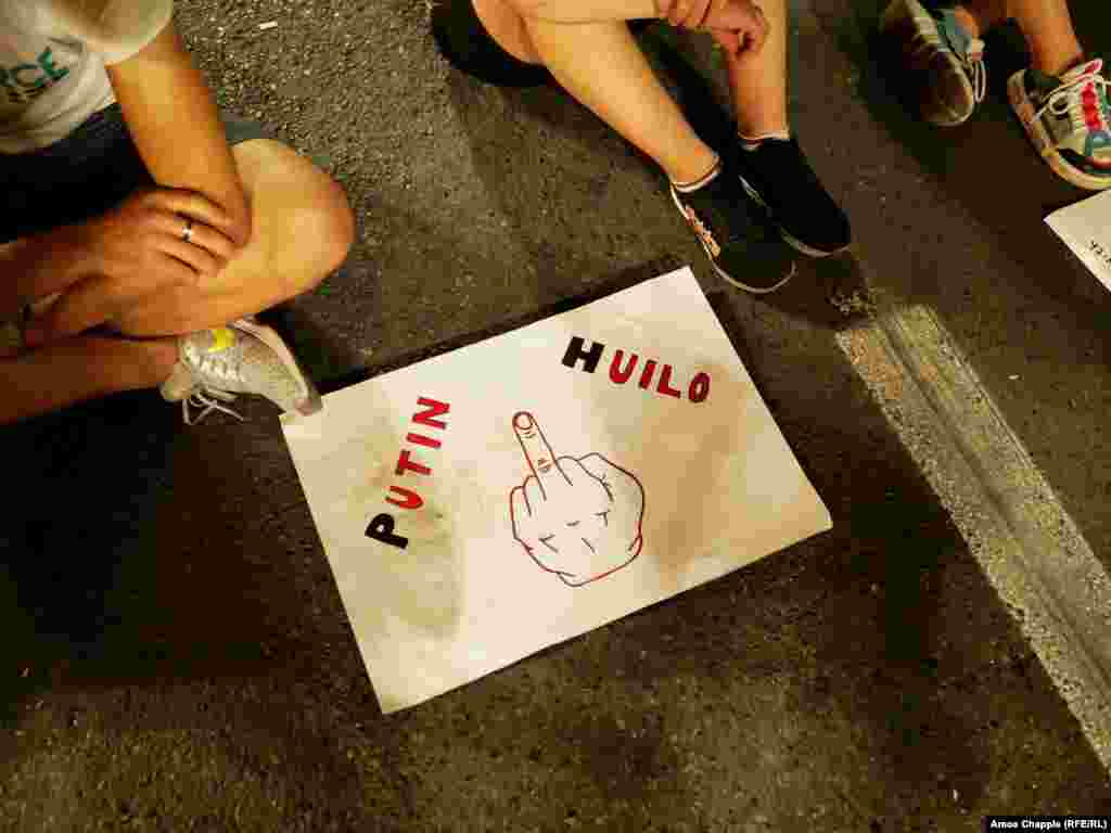 Anti-Russian sentiment was on display at the nighttime protest. This sign bears a slogan frequently used by antigovernment protesters in Russia: "Putin is a d***head."