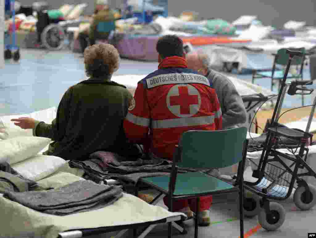 Rescue workers evacuate people in the eastern German city of Goessnitz.