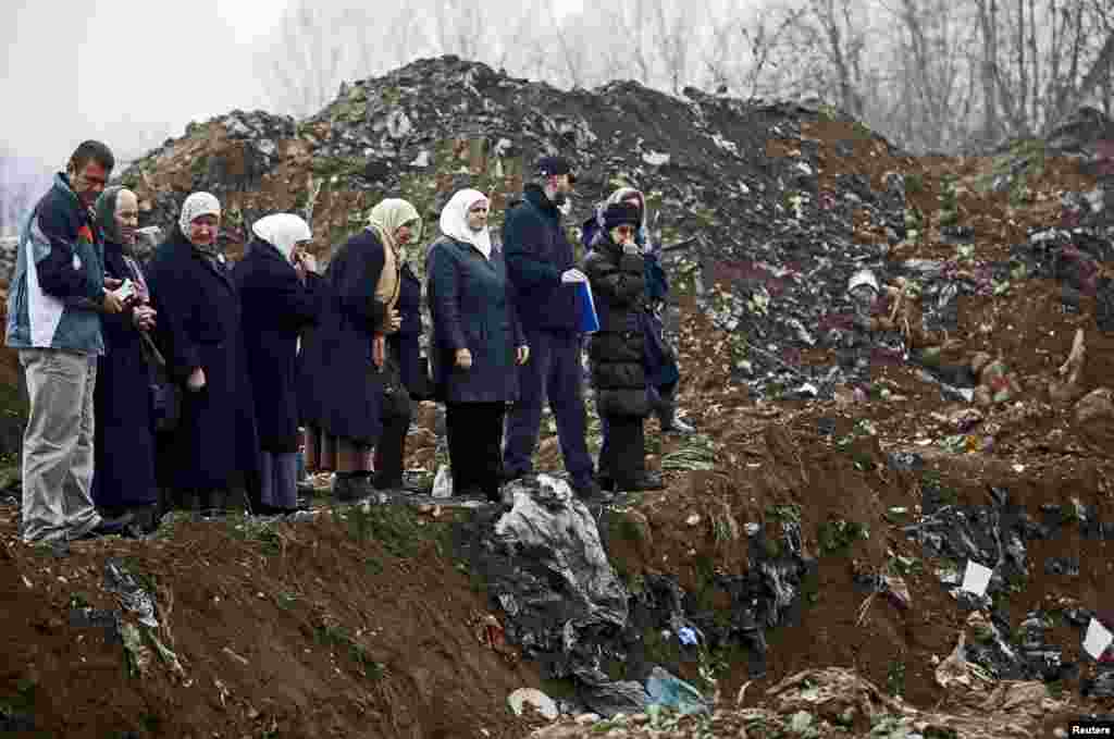 Women from Srebrenica cry during the exhumation of a mass grave believed to hold the bodies of massacre victims from the 1992-1995 war in Bosnia-Herzegovina, near the eastern town of Zvornik, on December 15.&nbsp;