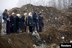 Women from Srebrenica cry during the exhumation in December 1995 of a mass grave believed to hold the bodies of victims who were massacred in the UN-designated "safe haven" during the Bosnian war.