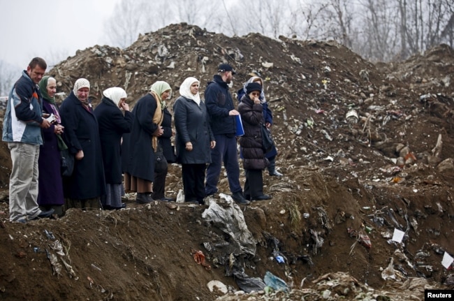 Women from Srebrenica cry during the exhumation in December 1995 of a mass grave believed to hold the bodies of victims who were massacred in the UN-designated "safe haven" during the Bosnian war.
