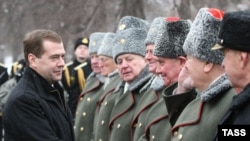 President Dmitry Medvedev (left) attends a wreath-laying ceremony at the Tomb of the Unknown Soldier in Moscow.