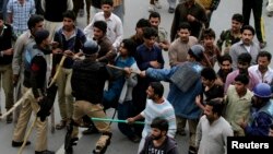 Protesters from Pakistan's Christian community clash with riot police on March 16, a day after suicide attacks on two churches in Lahore.