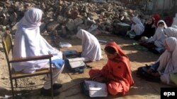 Girls sit amid the rubble of their destroyed school near the Afghan border, which was allegedly bombed by the Taliban militants in Bajaur in April.