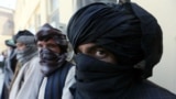 Former Taliban militants surrender their weapons during a reconciliation ceremony in Herat on August 3.