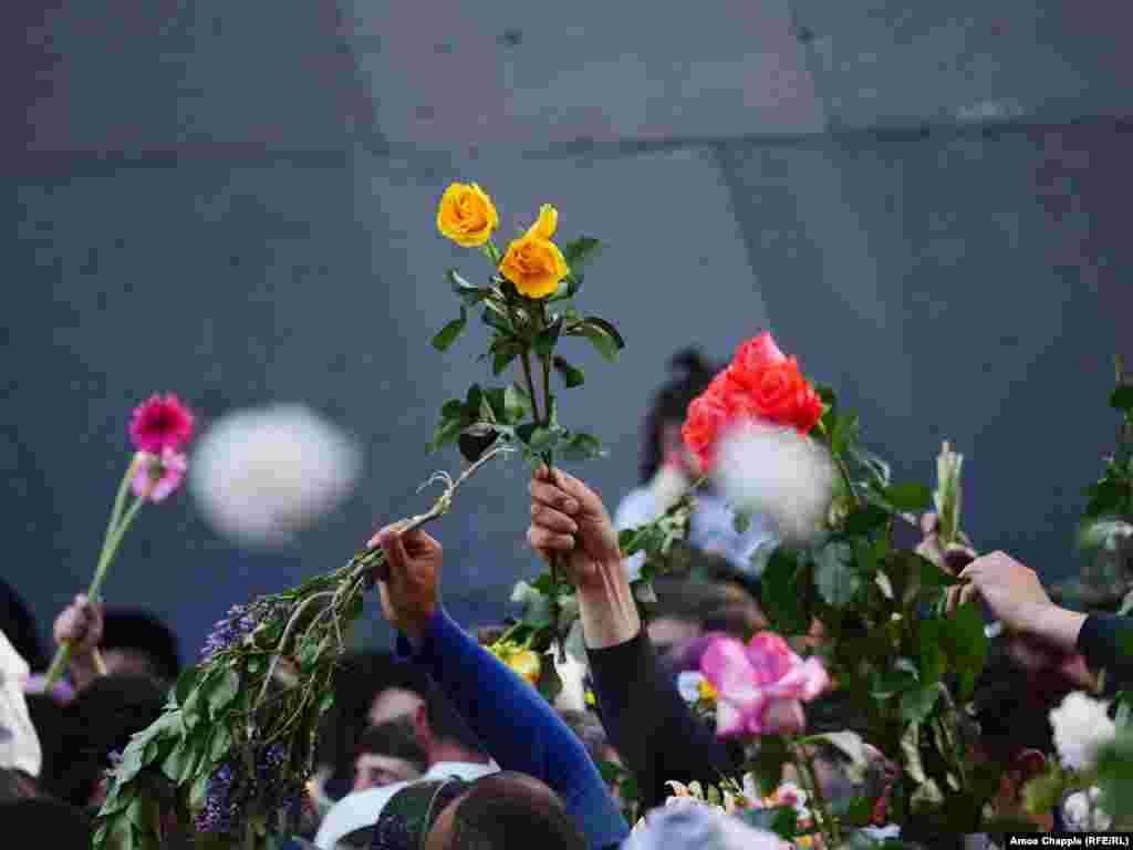 Armenians commemorate the anniversary of the mass killings by laying flowers around the eternal flame inside the Yerevan memorial. (RFE/RL/Amos Chapple)