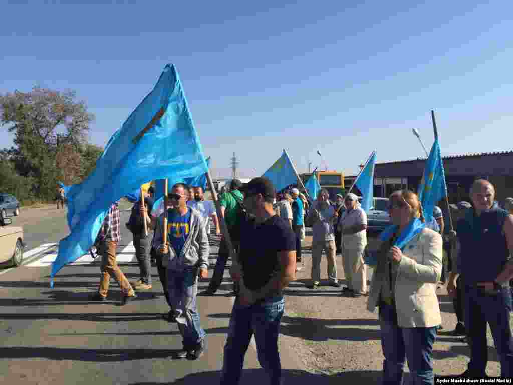 На Чонгарі присутні близько 150 чоловік. Багато хто з них тримає в руках кримськотатарські прапори